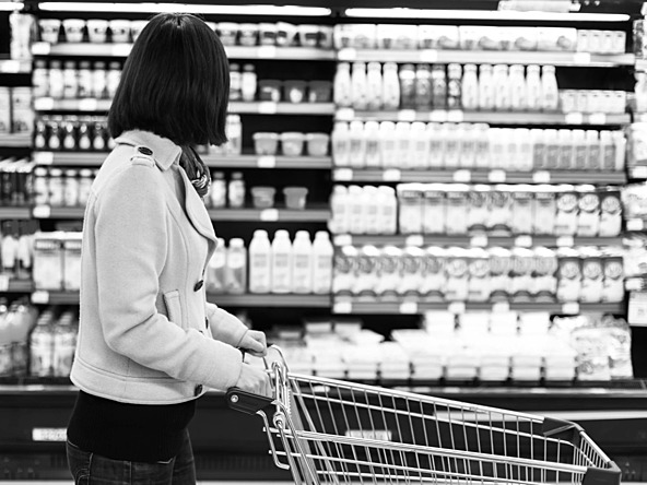 black and white photo of woman shopping in supermarket